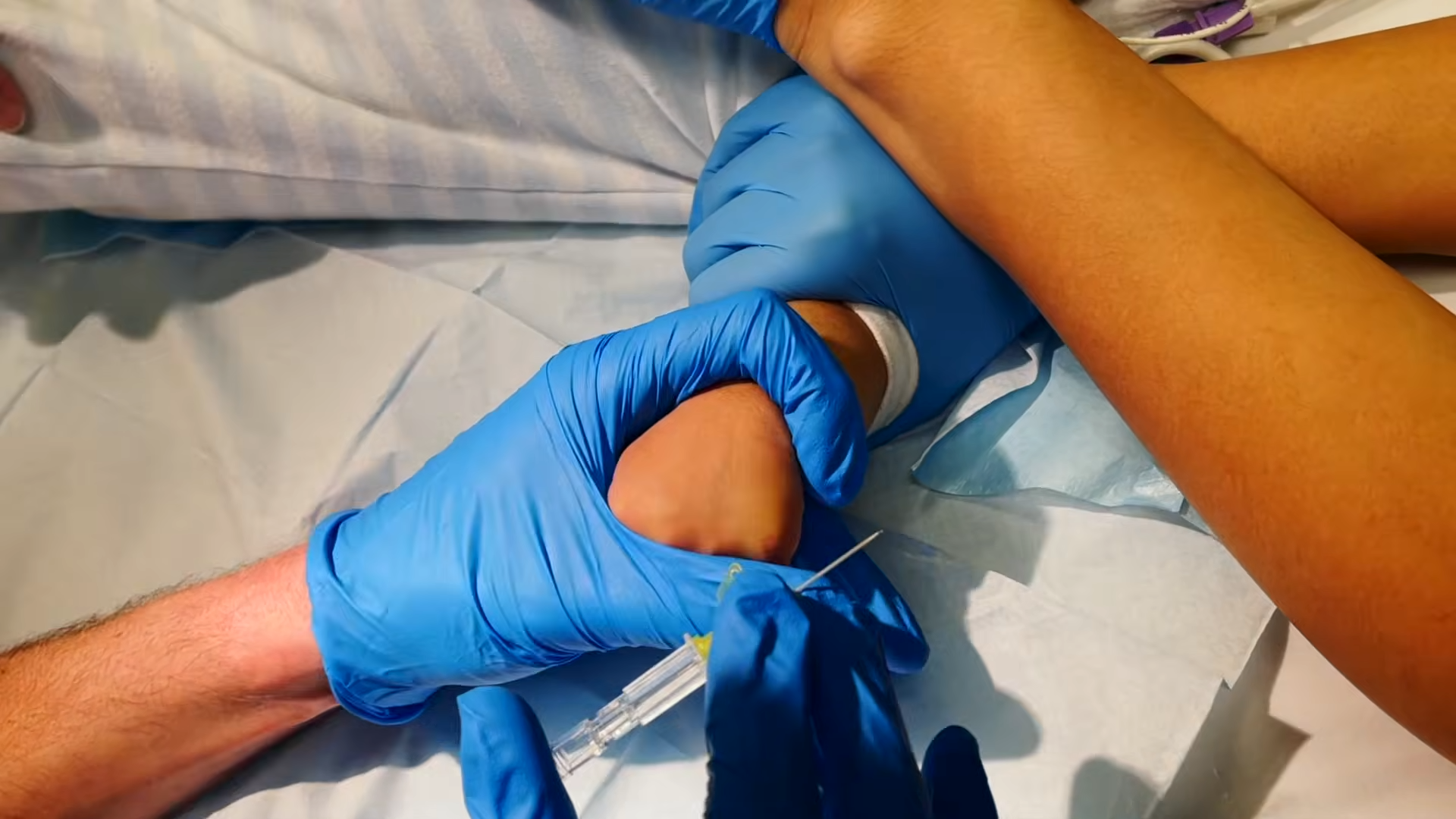 Holding the hand securely for venepuncture